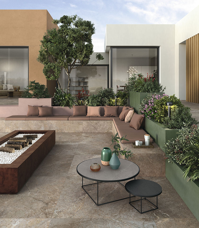 Contemporary terrace with stone-effect porcelain stoneware flooring, built-in seating, green planters and a lounge area with fire pit.